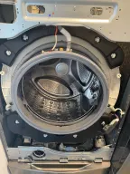 Front-load washer with the front panel off, from a Tech Parker job