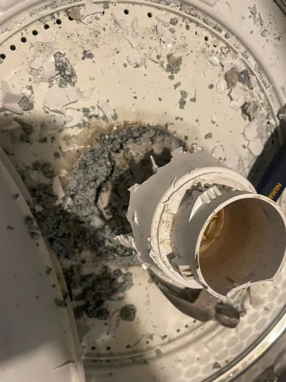 Broken agitator base inside a washer, from a Tech Parker job
